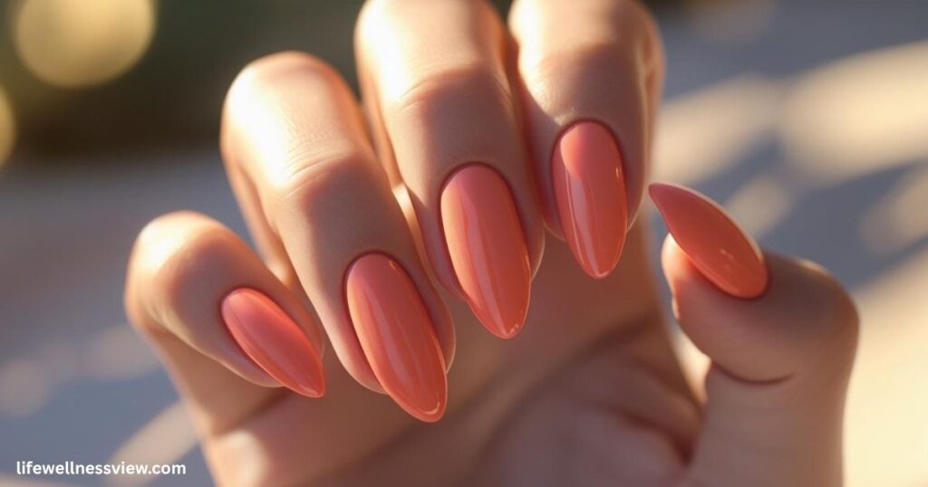 "Vibrant coral summer nails, trendy 2025 manicure idea for beach and vacation looks."